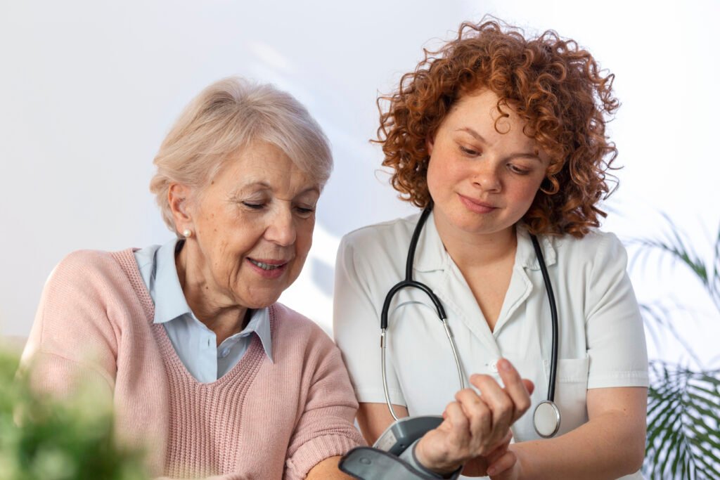 caregiver measuring blood pressure of senior woman at home. kind carer measuring the blood pressure of a happy elderly woman in bed in the nursing home.