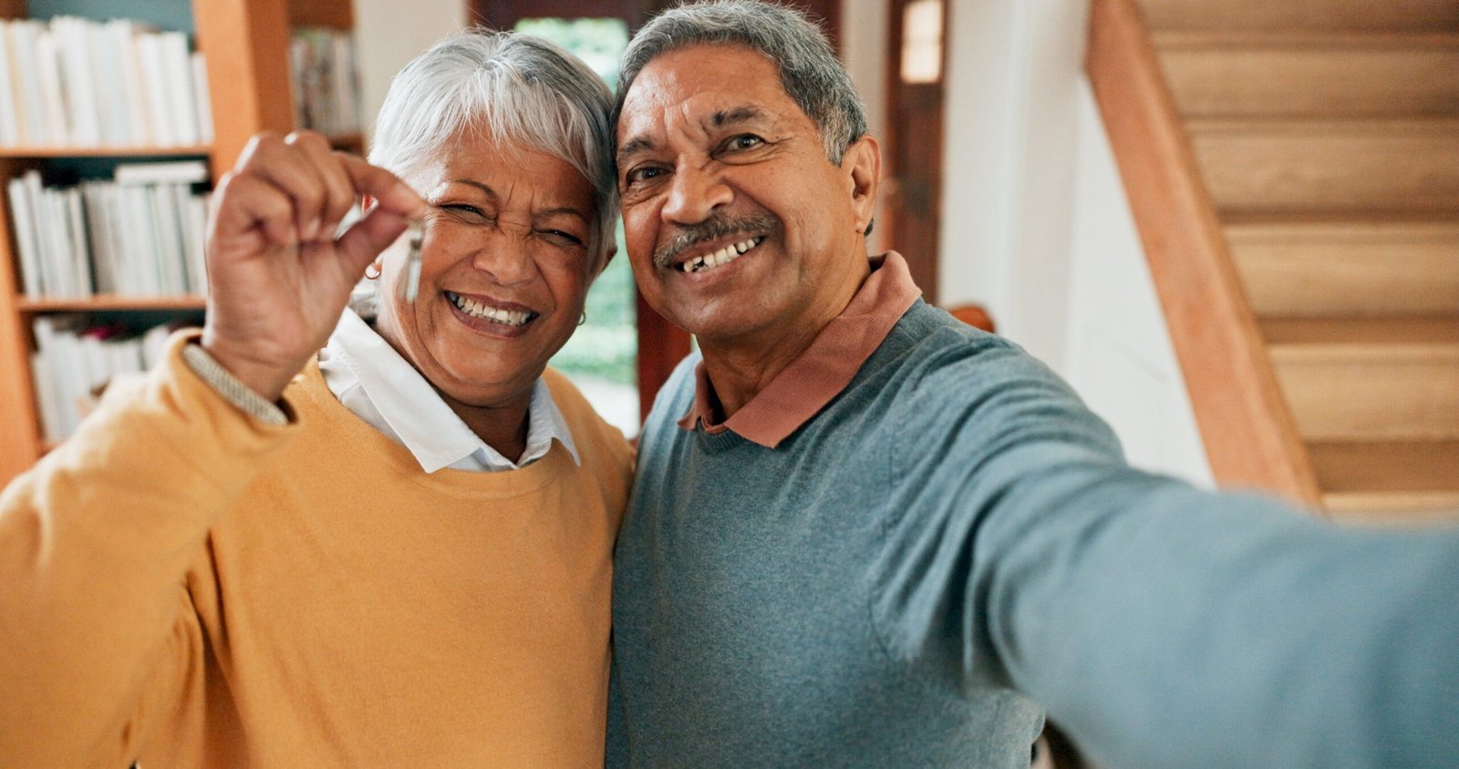 house keys selfie portrait old couple new home with property investment loan success moving profile picture senior people retirement with security real estate deal relocation scaled.jpg
