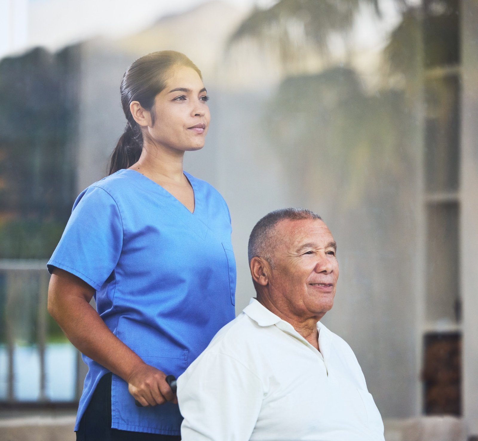 nurse caregiver senior man wheelchair nursing home hospital clinic surgery recovery wellness physiotherapy thinking healthcare worker retirement disability elderly insurance scaled.jpg
