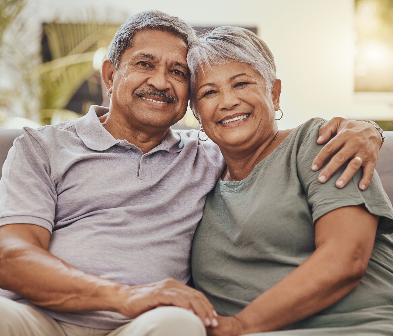 senior couple portrait home elderly people happy about marriage love retirement relax happiness house sofa with old woman man together with care hug feeling peace scaled.jpg